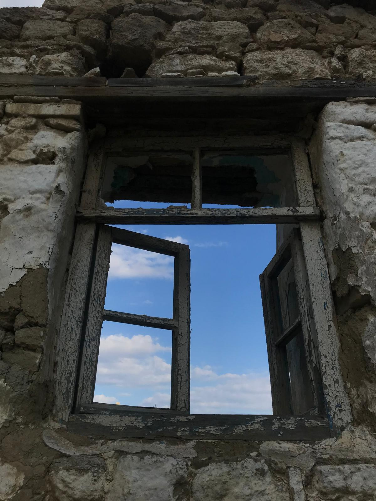 Open window overlooking blue sky